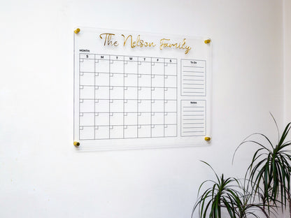 Acrylic wall calendar in a living room with a plant