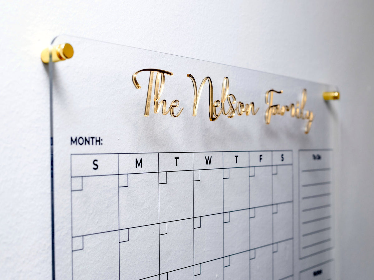 Close-up of raised 3D gold acrylic letters on the clear planner