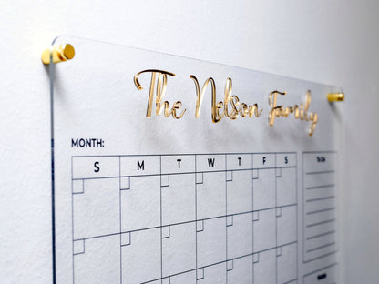 Close-up of raised 3D gold acrylic letters on the clear planner