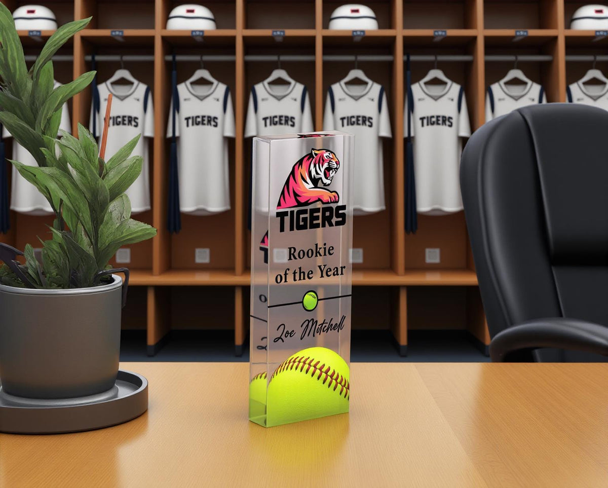 Acrylic softball trophy in front of team jerseys in a locker room