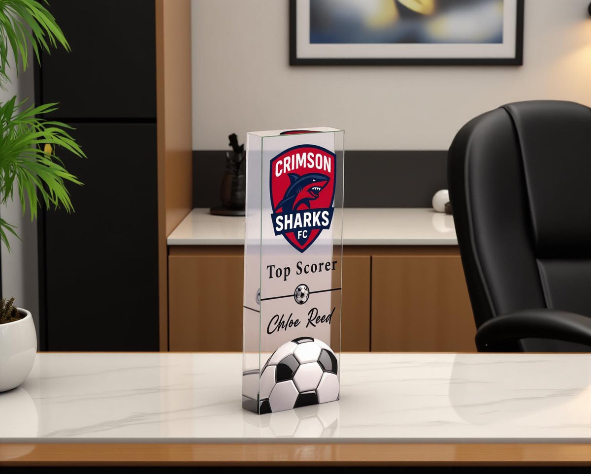 Acrylic soccer trophy on a marble desk