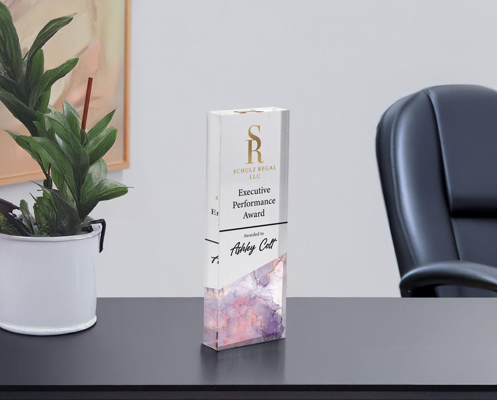 Custom acrylic corporate award with company logo, Executive Performance Award title and name on an office desk