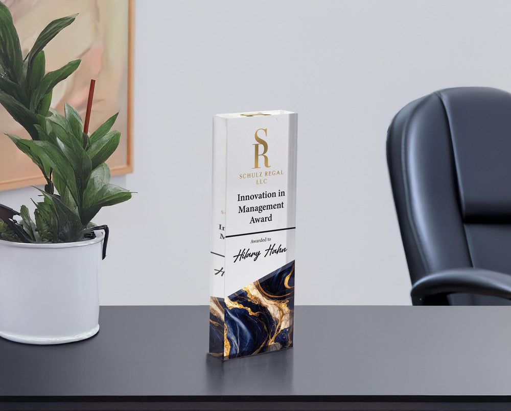 Clear acrylic Innovation in Management award with navy and gold marble base